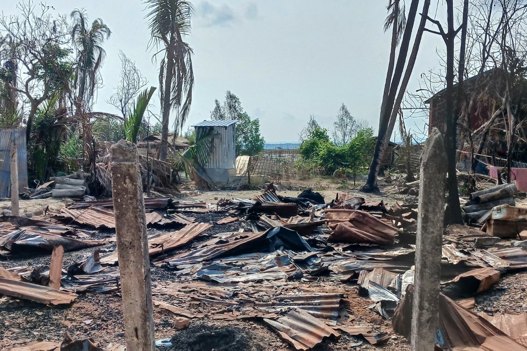 This photo taken on May 21, 2024 shows a destroyed house and burned trees following fighting between Myanmar's military and the Arakan Army (AA) ethnic minority armed group in a village in Minbya Township in western Rakhine State. Fighting has rocked Myanmar's western Rakhine state since the Arakan Army (AA) attacked the junta there in November last year, and according to the UN more than 100,000 people have been displaced by conflict in the state since then. (Photo by AFP) / To go with 'MYANMAR-CONFLICT-COUP-RAKHINE'