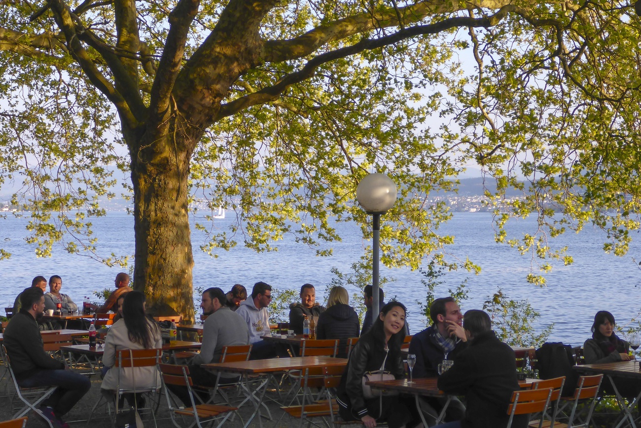 persone sedute in un bar in riva a un fiume