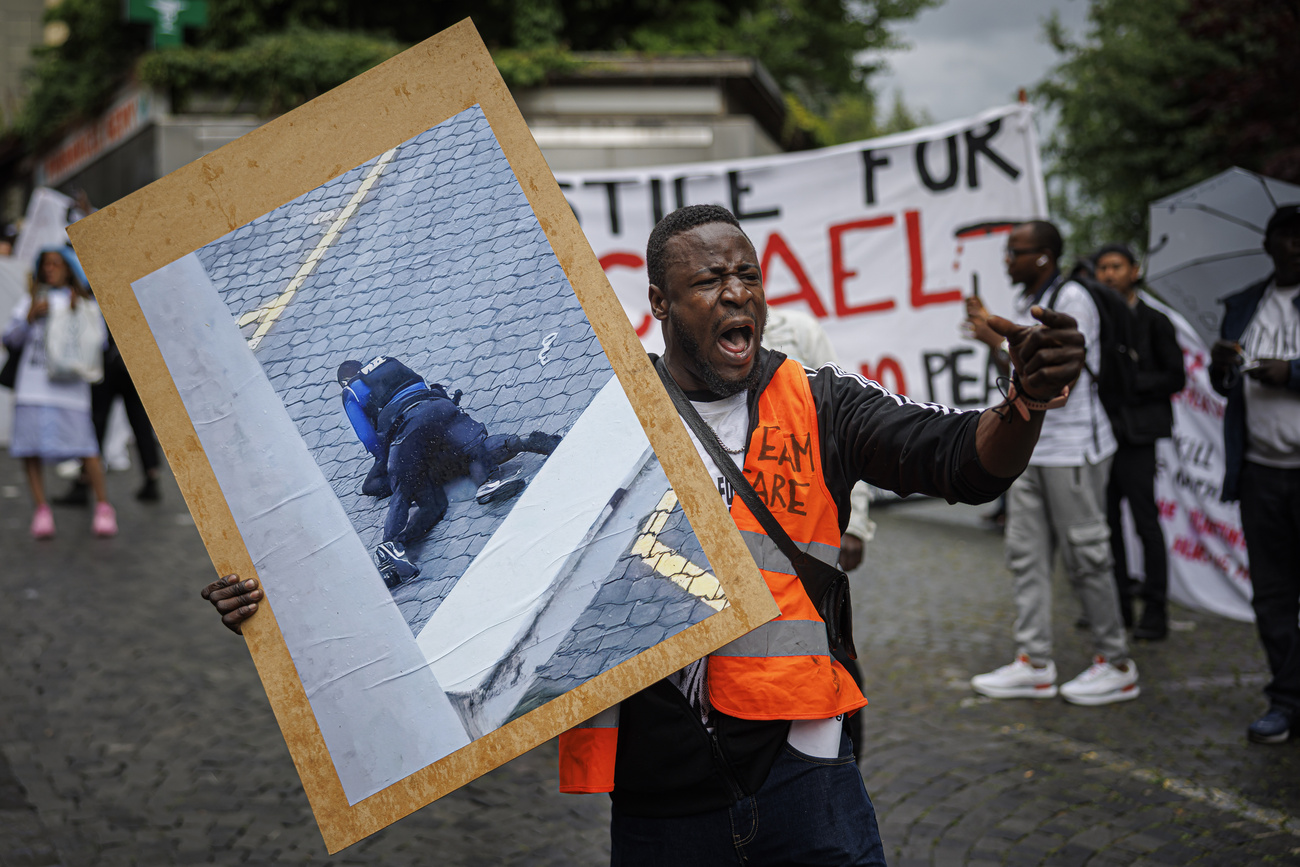 demonstrator in orange vest
