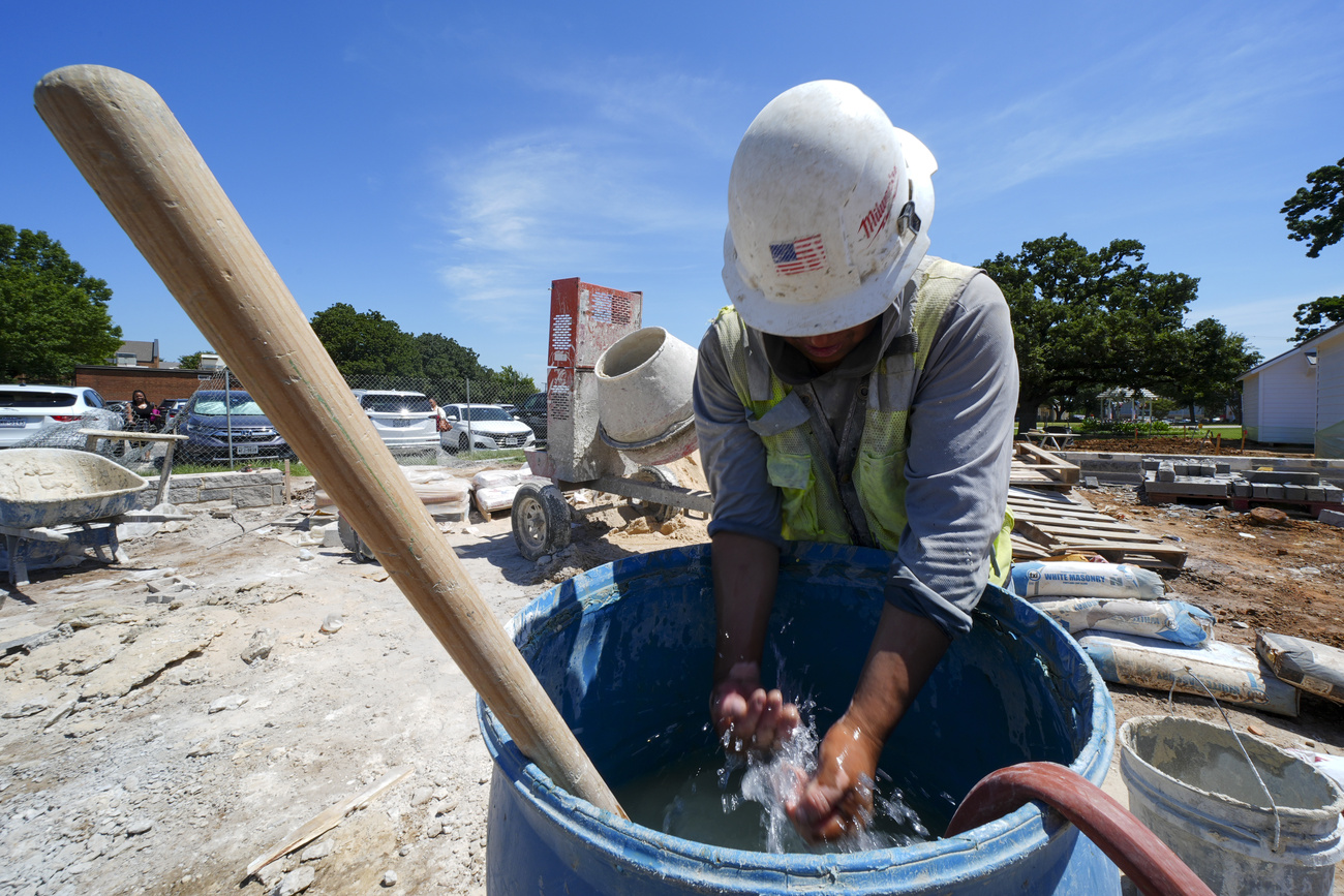 extreme heat work health. Construction worker Justino cools off during a heat wave in Texas.