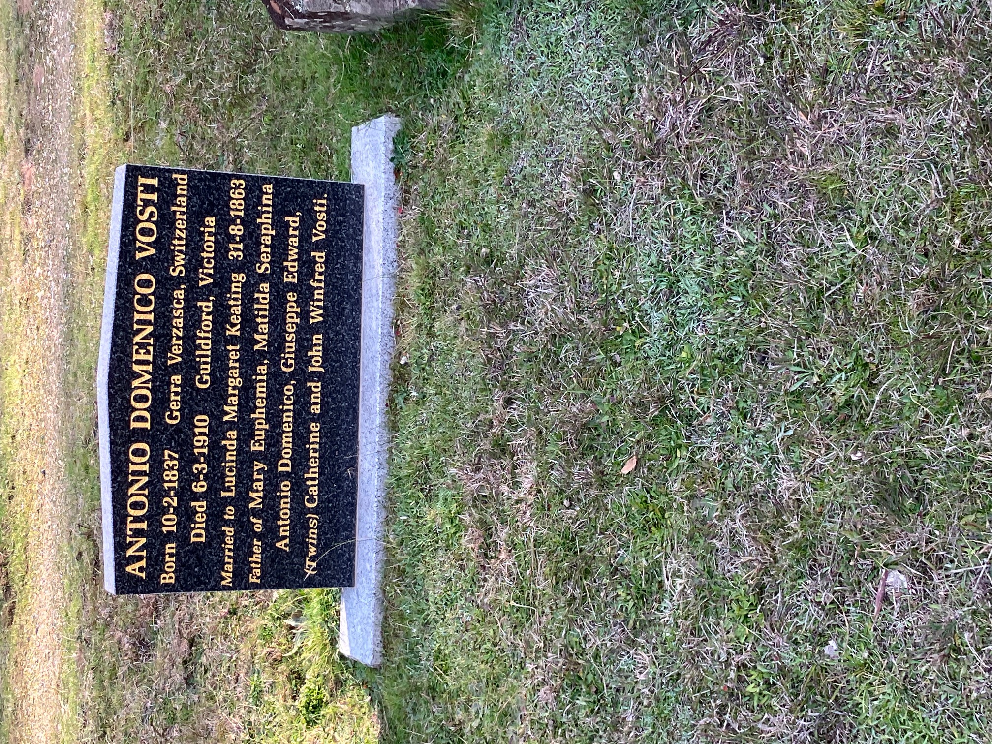 Black grave inscribed in yellow font