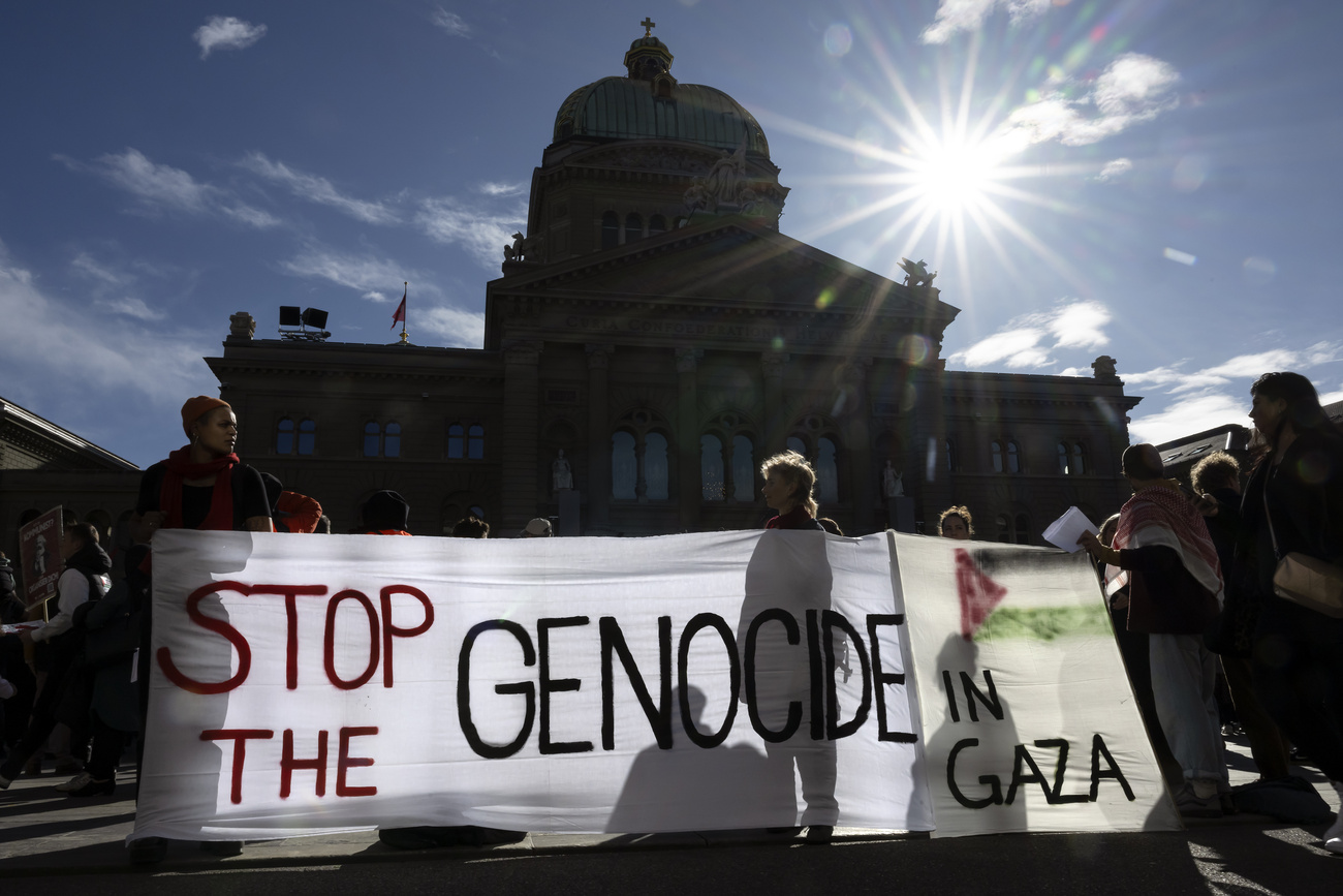 Protesters hold Palestinian flags and placards during an authorized rally in solidarity with Palestine, front of the Federal Palace, at the Federal square, in Bern, Switzerland, on Saturday, October 28, 2023. Thousands of Israelis and Palestinians have died since the militant group Hamas launched an unprecedented attack on Israel from the Gaza Strip on 07 October 2023, leading to Israeli retaliation strikes on the Palestinian enclave.