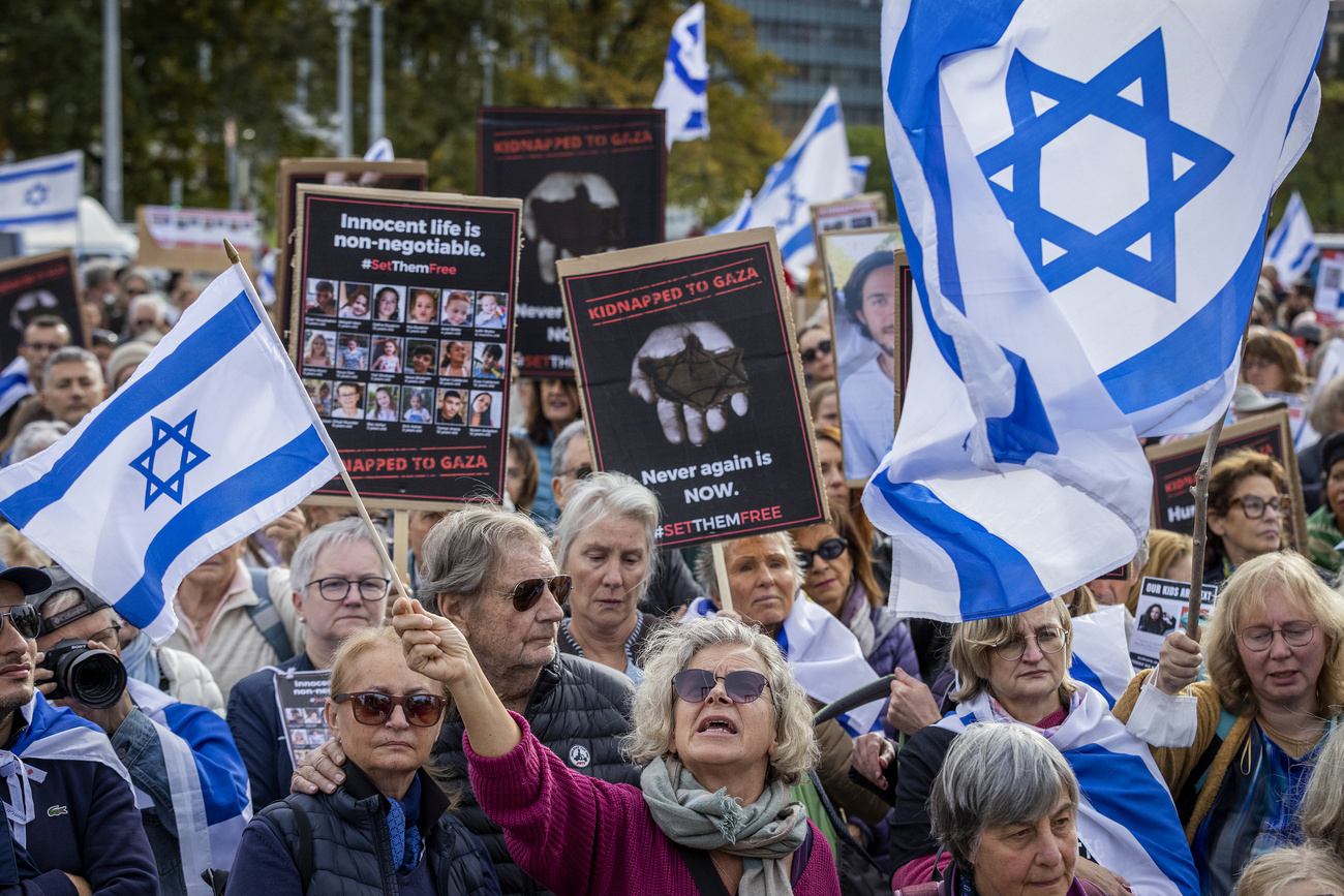 Protesters hold banners with hostages' pictures and Israel national's flags during a gathering next to the European headquarters of the United Nations in Geneva, Switzerland, Sunday, October 22, 2023. Thousands of people, both Israeli and Palestinians have died since October 7, 2023, after Palestinian Hamas militants based in the Gaza Strip, entered southern Israel in a surprise attack leading Israel to declare war on Hamas in Gaza on October 8.