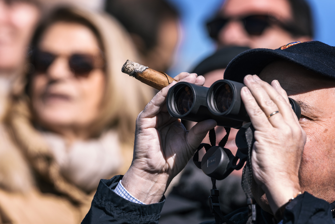 man with binoculars and a cigar