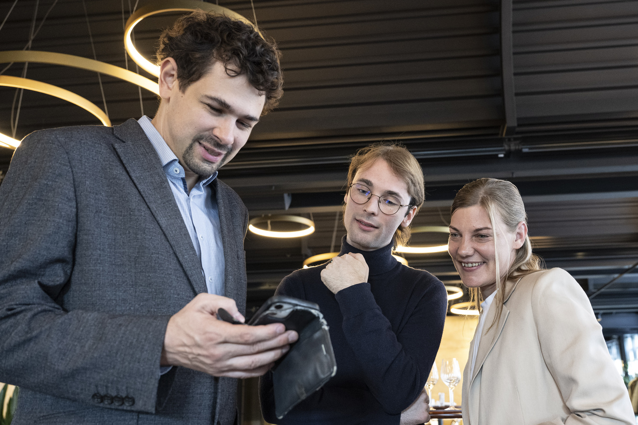 Photo of people looking at a smartphone