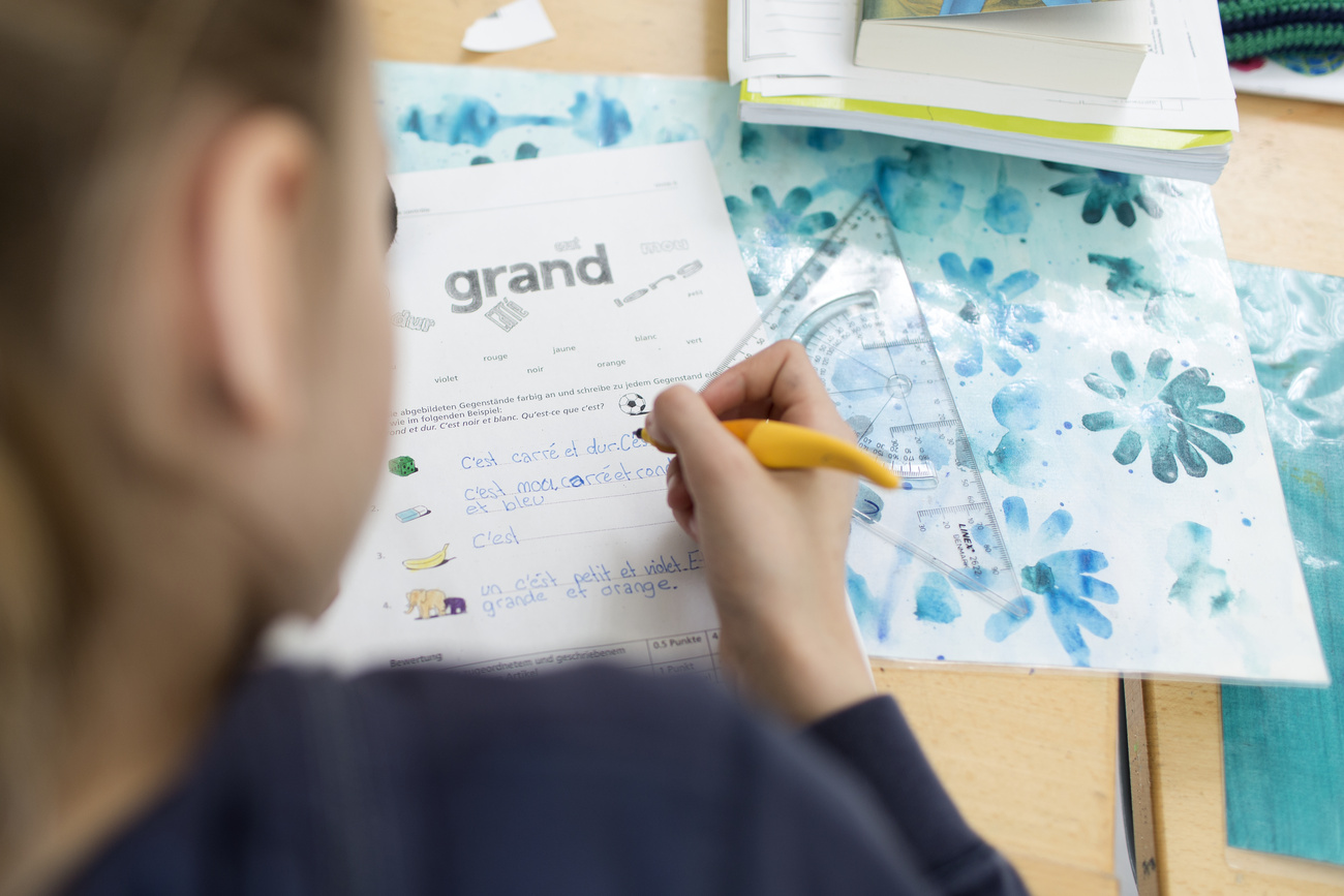 A child writes in French - bilingual teaching is rare in Switzerland.