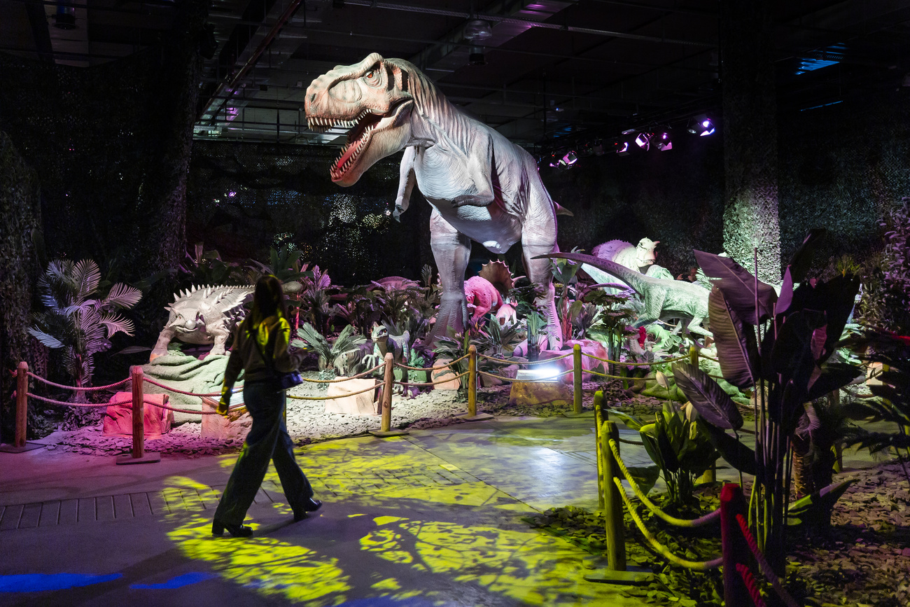 Persona vicino a plastico di dinosauro
