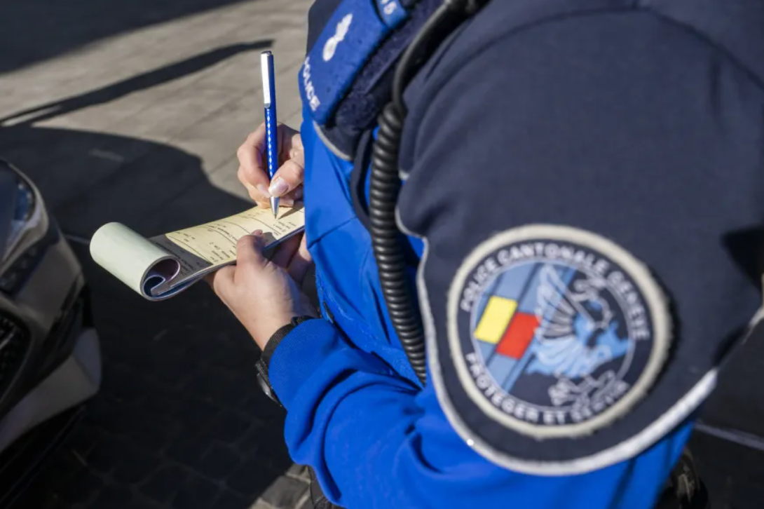 eine Person in Uniform schreibt einen Bussenzettel