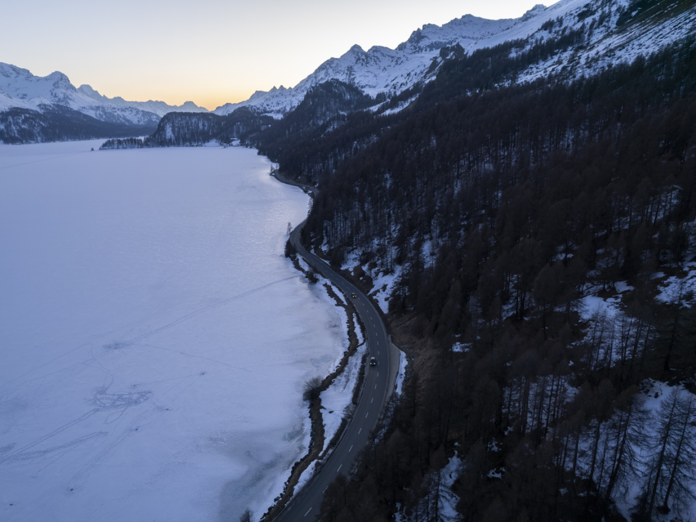 strada di fianco a un lago innevato