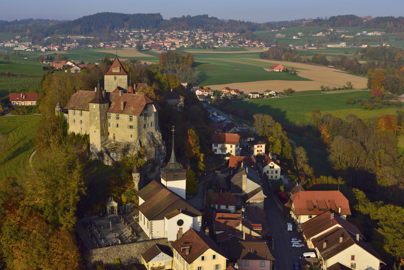 A real postcard image: the small town of Rue, perched around a rocky promontory dominated by a medieval castle.