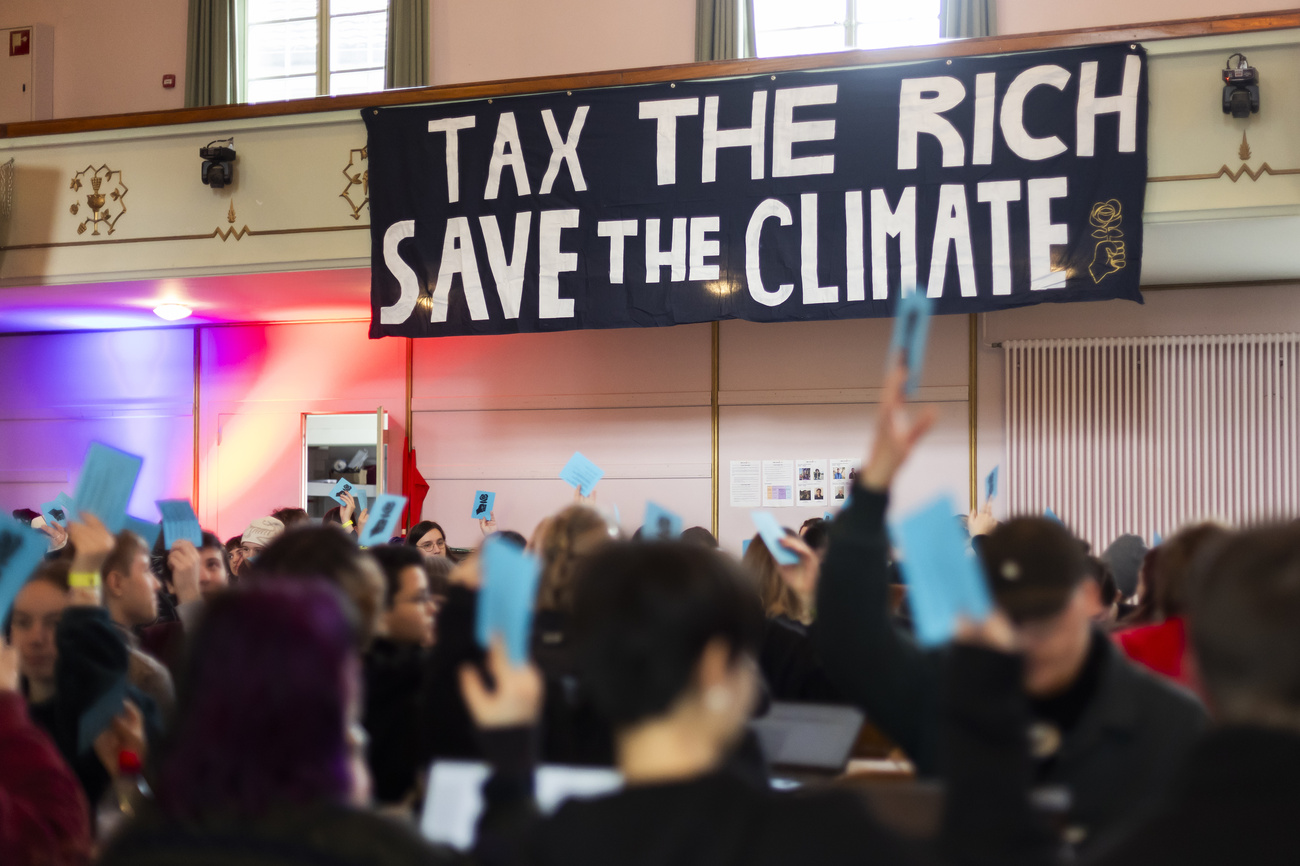 banner reading "tax the rich"