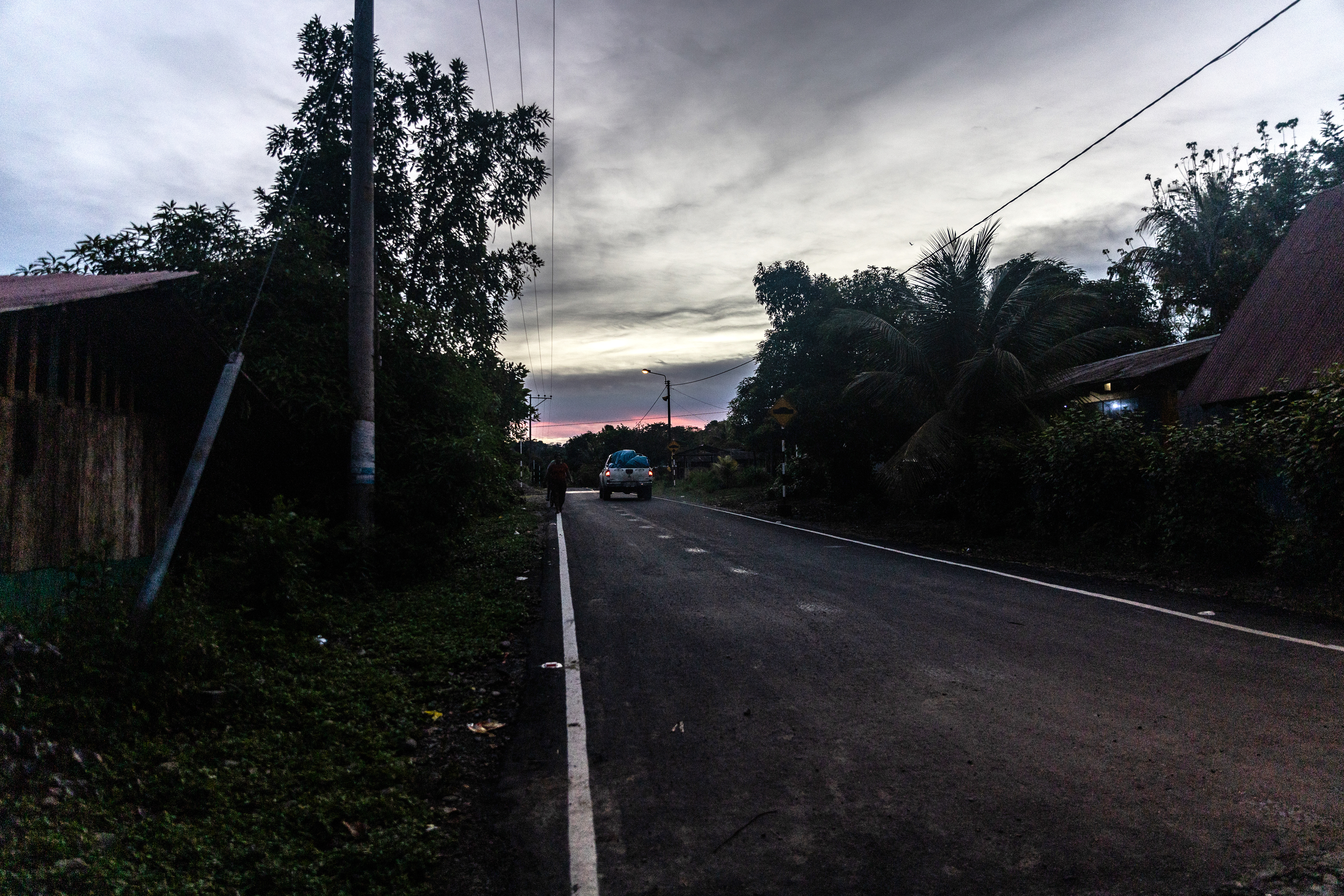 A car driving along a deserted road at night