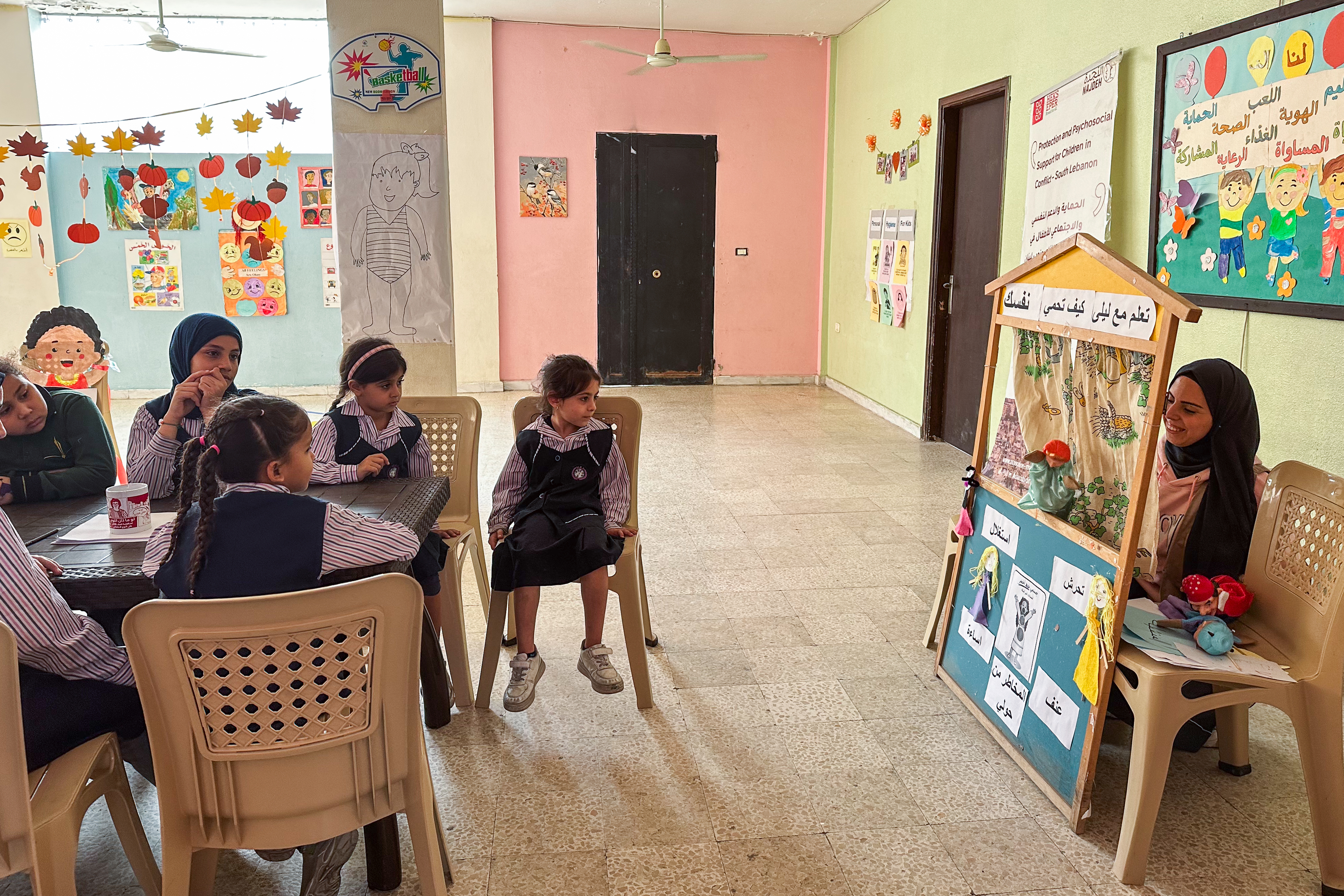 Girls watch a puppet theatre