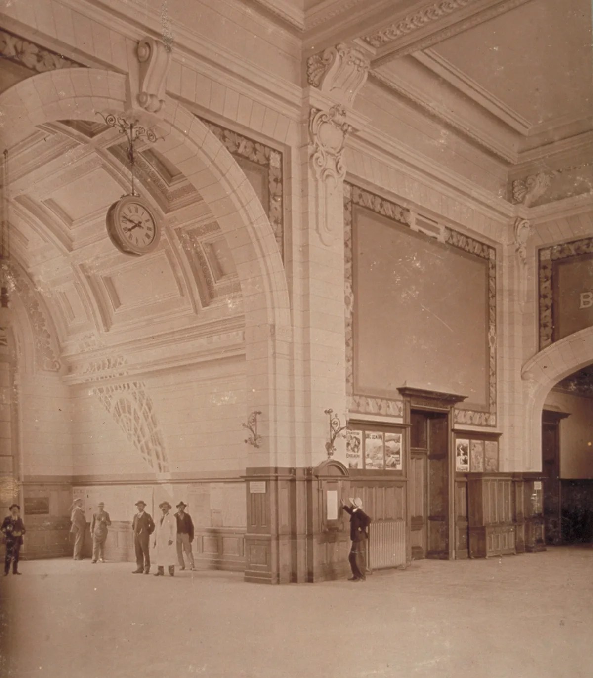 Station concourse in La Chaux-de-Fonds with large clock, circa 1900.