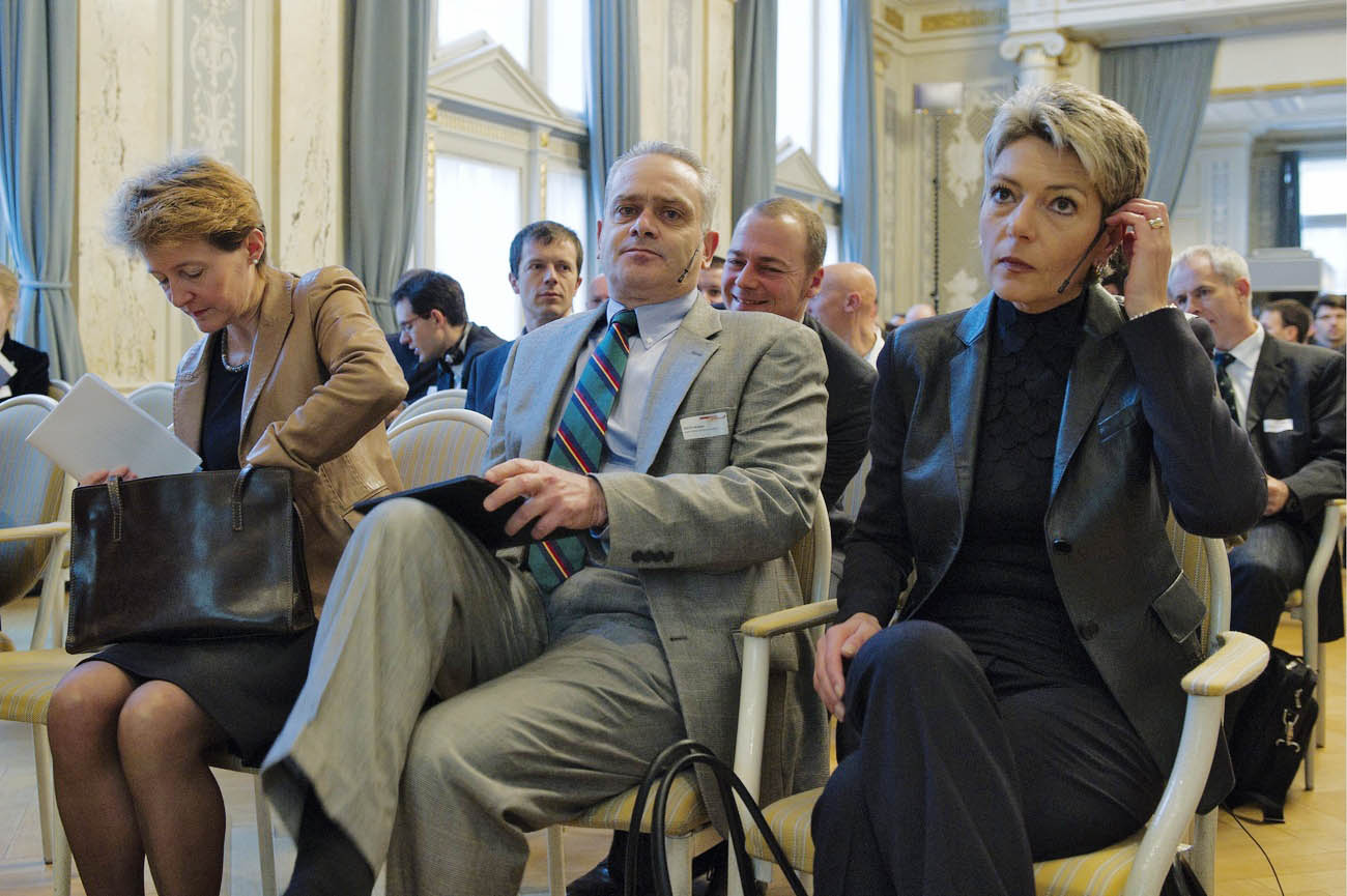 two women and a man, in suits