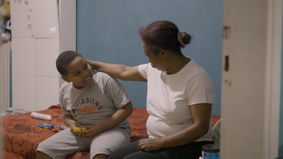 Woman and boy sit next to each other