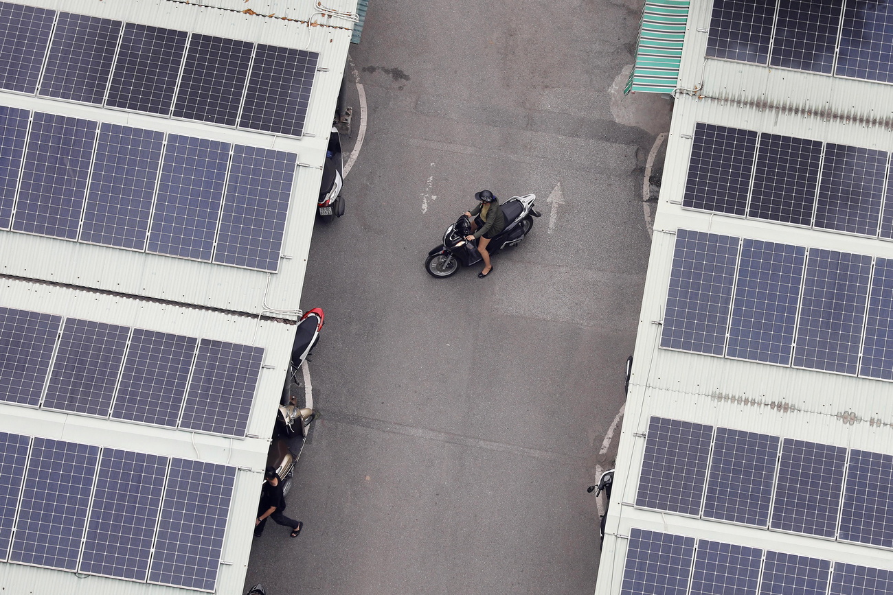 Solar panels are seen on the rooftop of a parking garage in Hanoi, Vietnam