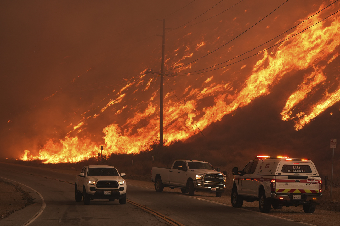 Firefighters monitor flames in Castaic, California, on January 22, 2025.