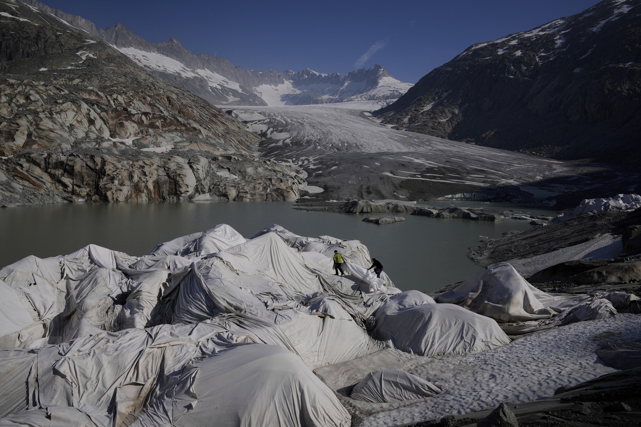View of the Rhone Glacier, near Goms, in Switzerland. Parts of the glacier are covered by sheets to protect them from melting.