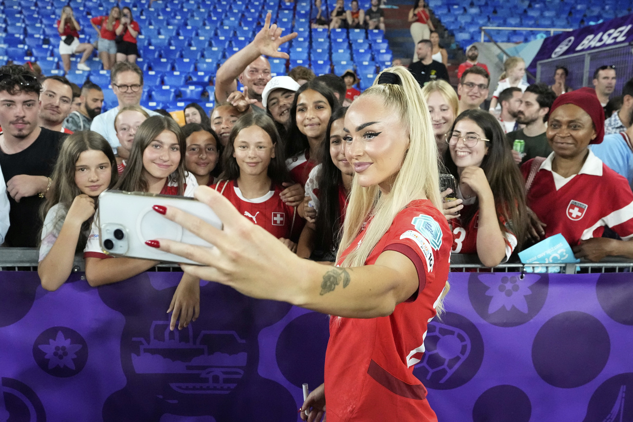 una calciatrice scatta un selfie con un gruppo di ragazze