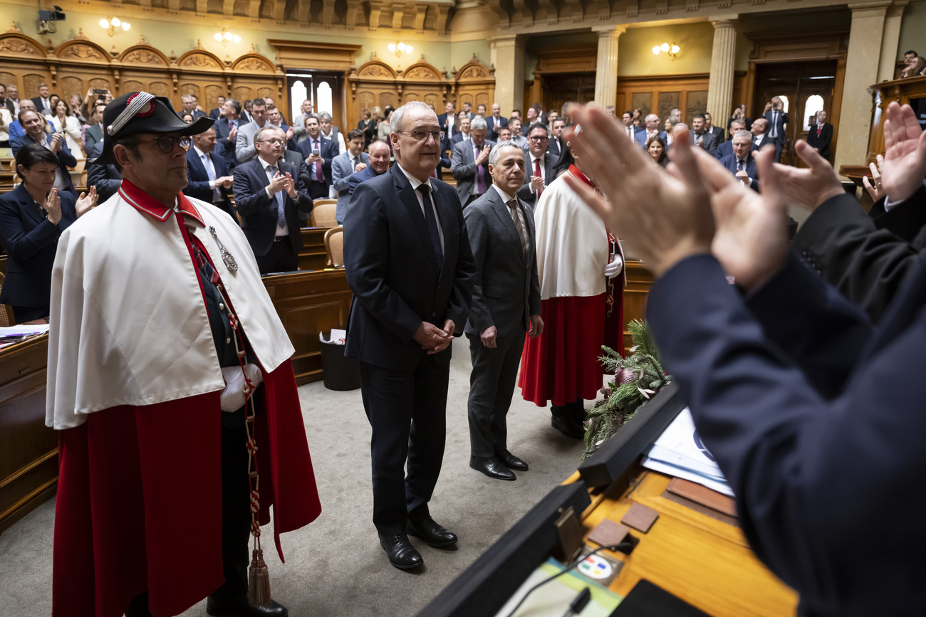 Two men are sworn in at a parliament