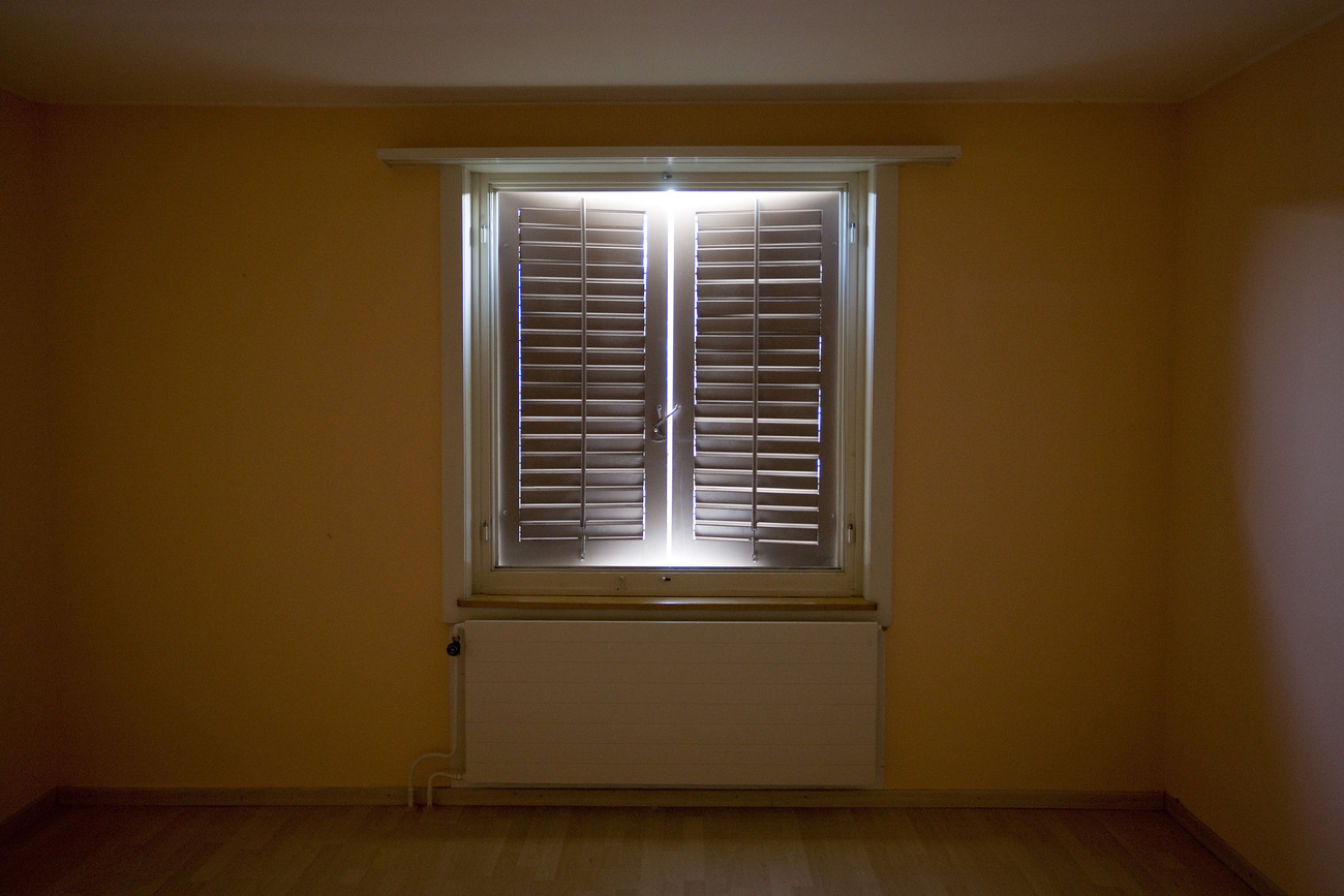 View of a closed window in a run-down Zurich flat.