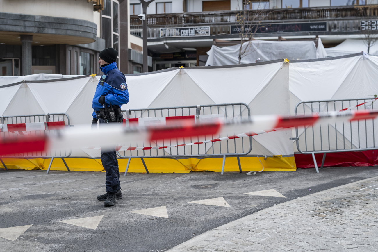 Police office in front of cordoned off Le Constellation bar in Crans-Montana