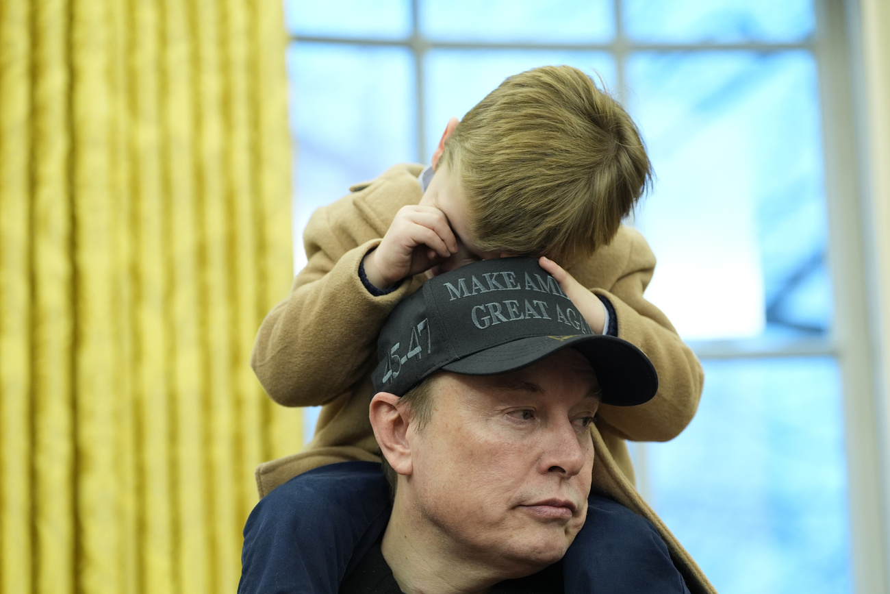 Elon Musk, joined by his son X Æ A-Xii, speaks in the Oval Office at the White House, Tuesday, Feb. 11, 2025, in Washington, during an event with President Donald Trump.