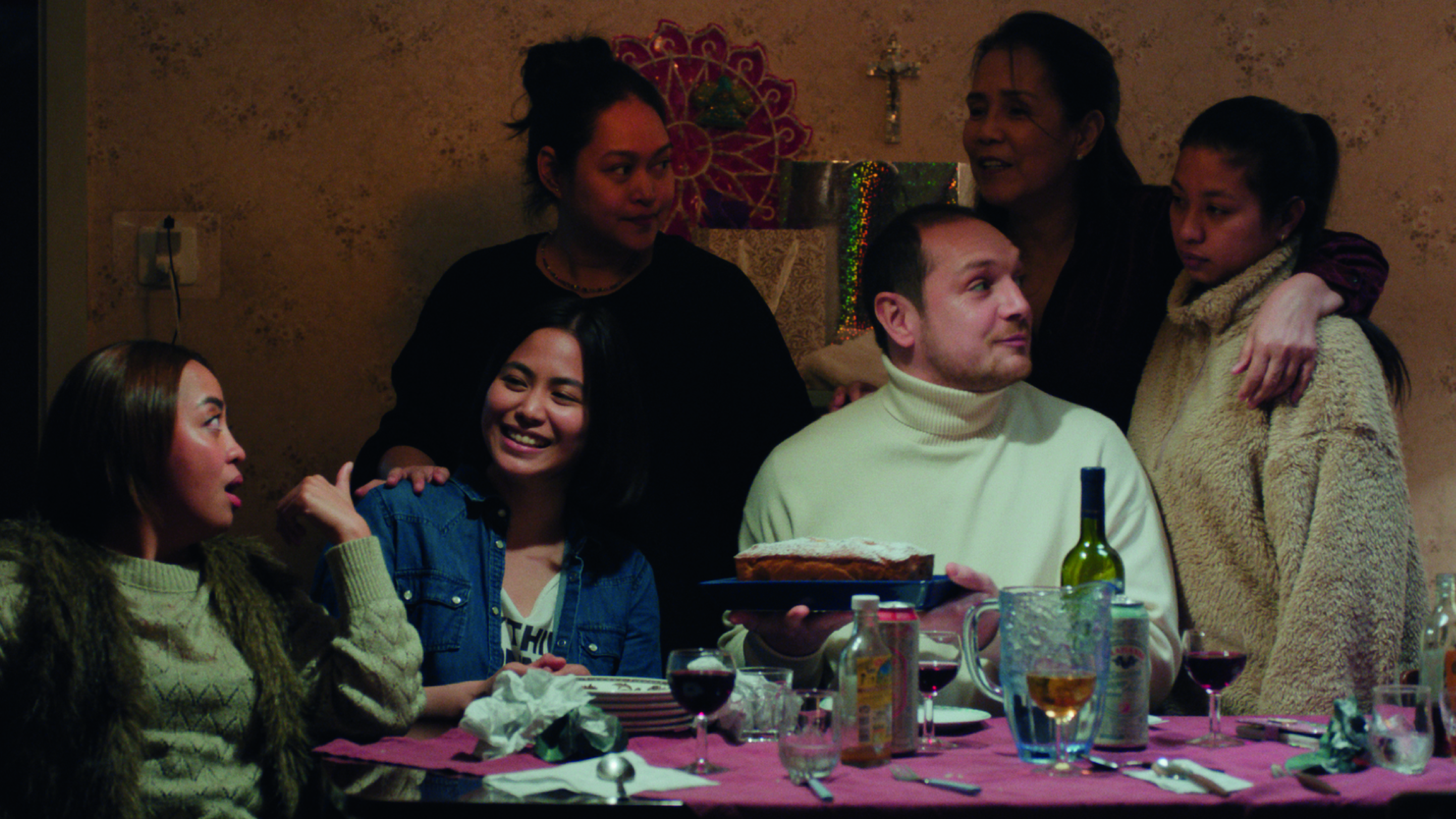 Mercedes Cabral's character, Luz (at the center), with colleagues and their boss (guess who); To avoid losing custody of her daughter, who remains in Manila, she must raise the necessary funds, at the risk of cutting herself off from her community and crossing her own moral boundaries.