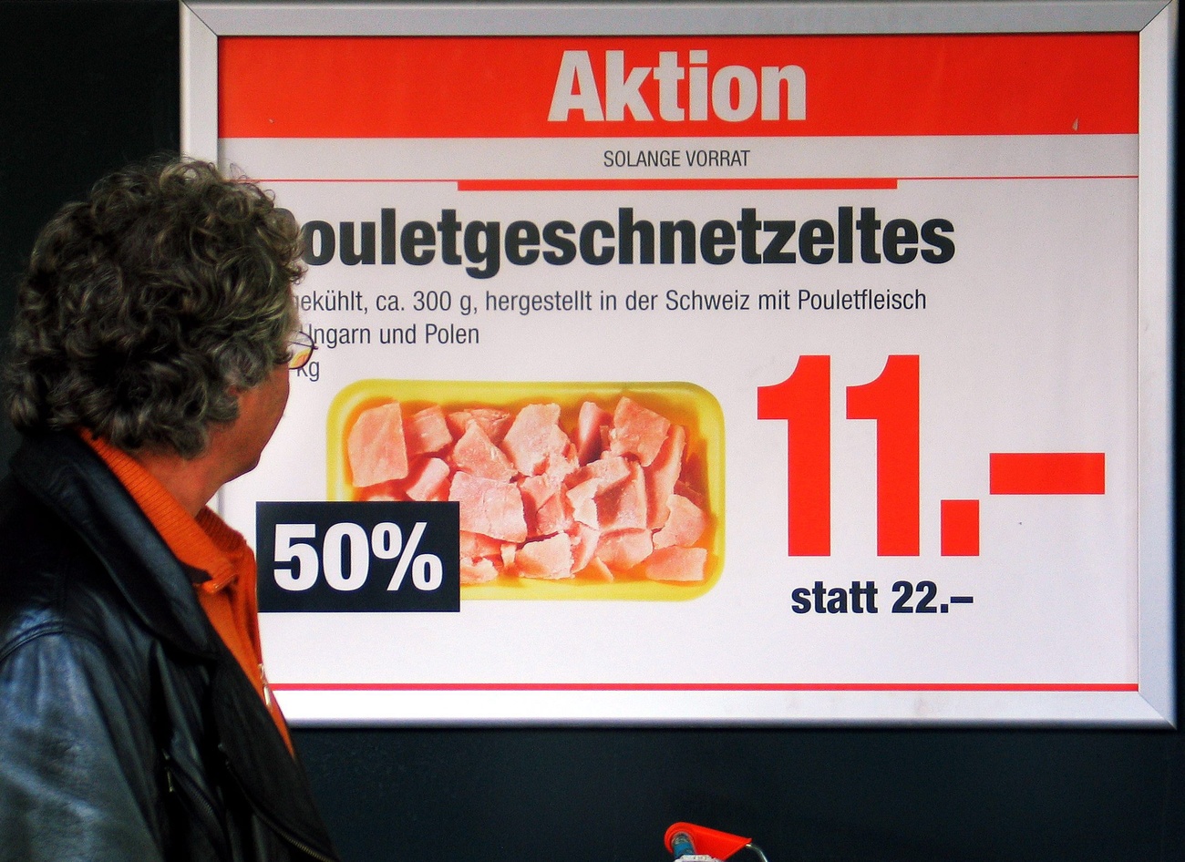A poster advertising discounted chicken at a major Swiss retailer.
