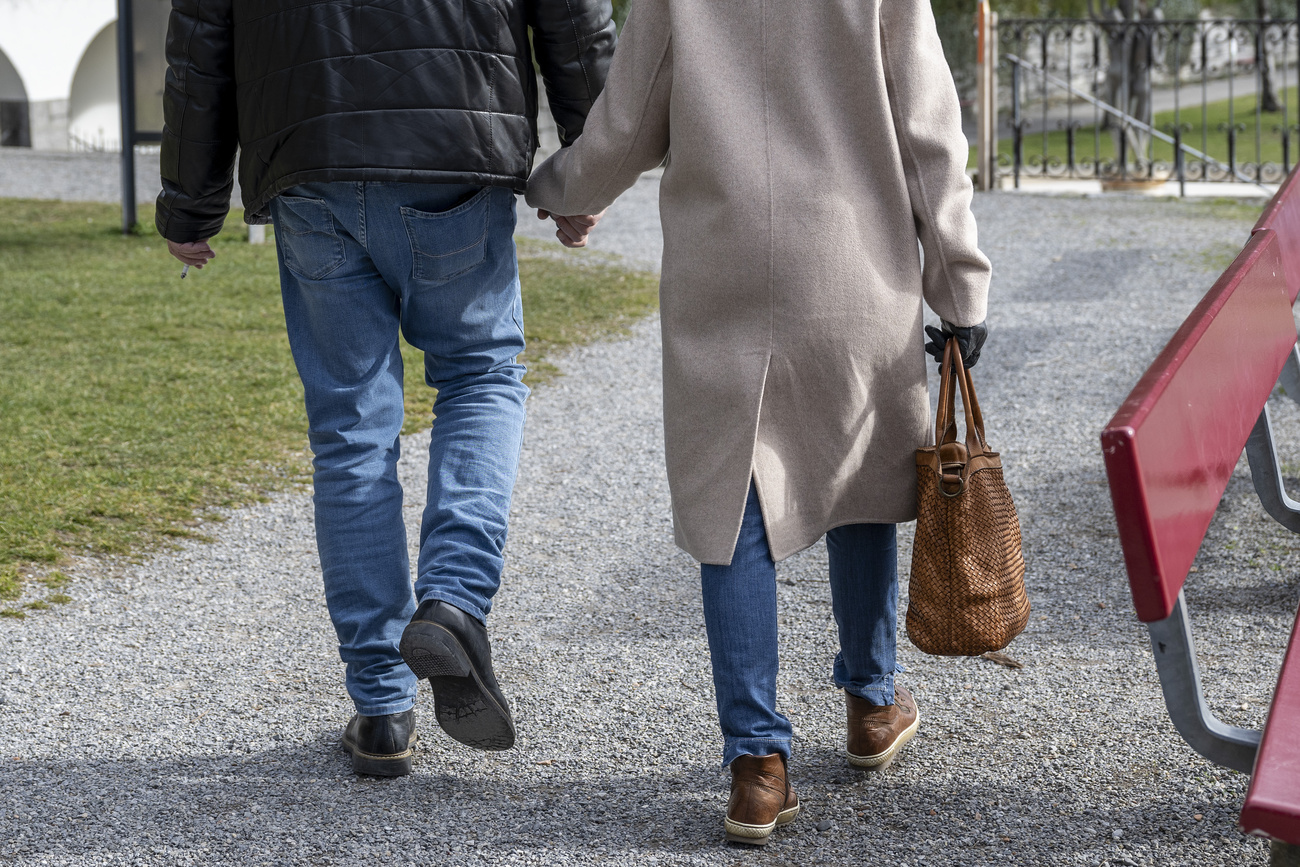 Photo of man and woman walking in the street