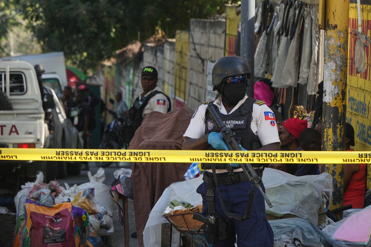 Police stand guard at the corner where officers foiled an attempted kidnapping in the Delmas district of Port-au-Prince, Haiti, February 2026
