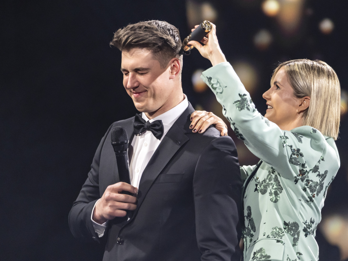 Von Allmen gets his hair shaved in front of a live audience