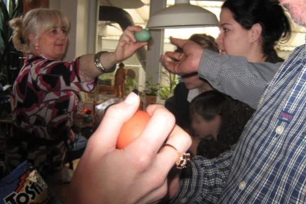 People holding boiled colourful eggs