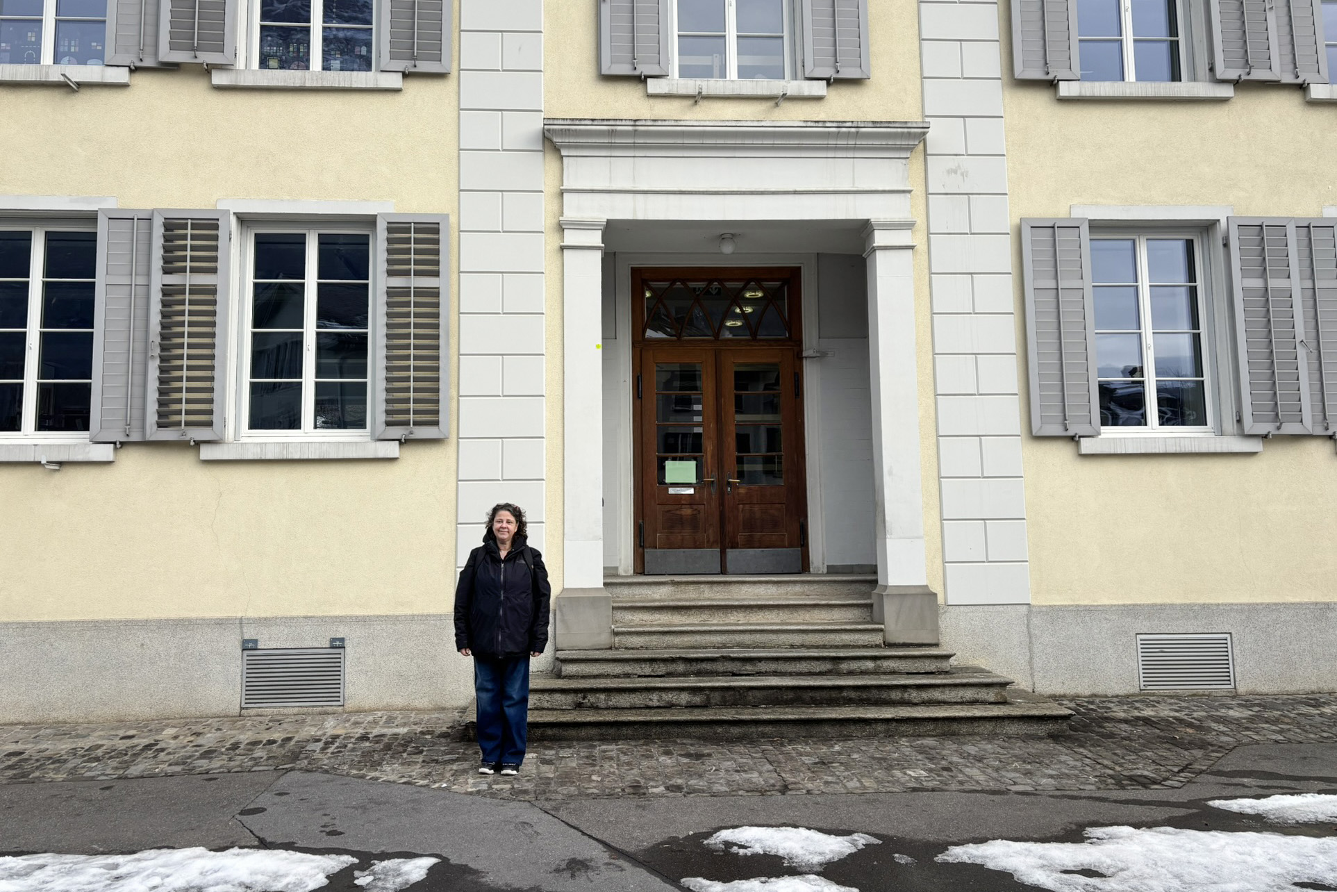Tammy Mackenzie standing in front of her grandmother's elementary school.