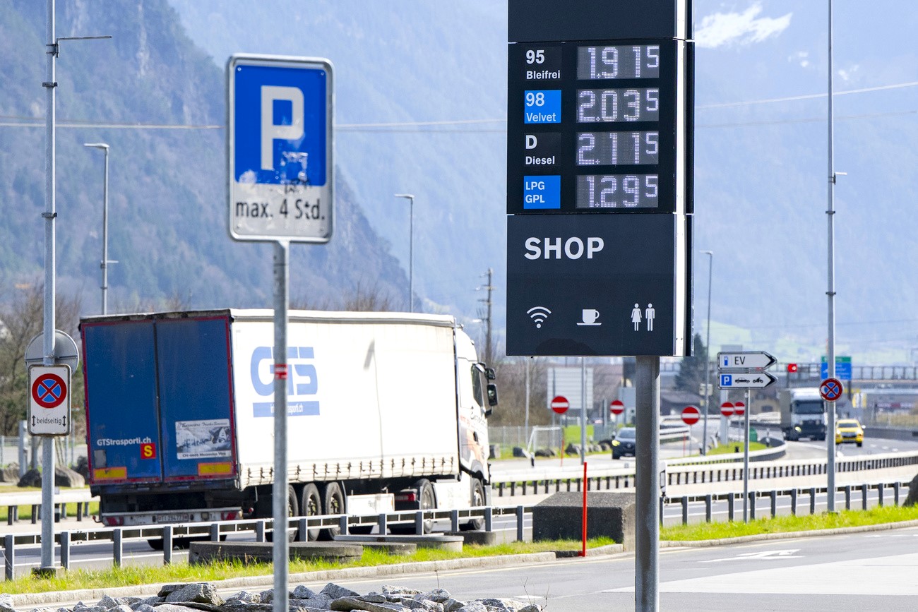a lorry driving past a petrol station