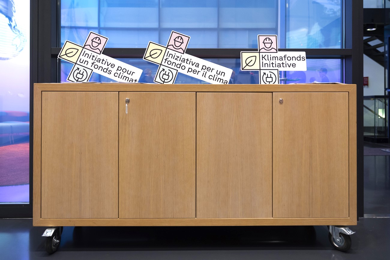 information material on the climate fund initiative displayed on a cabinet