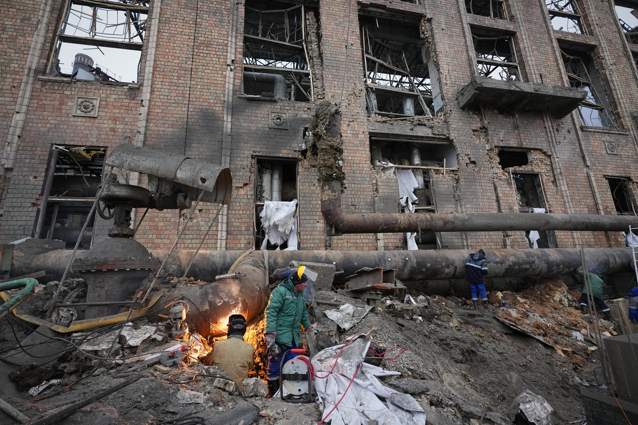 Workers clean up the damage at the Darnytsia thermal power plant in Kyiv, Ukraine, following a Russian attack on 4 February 2026.