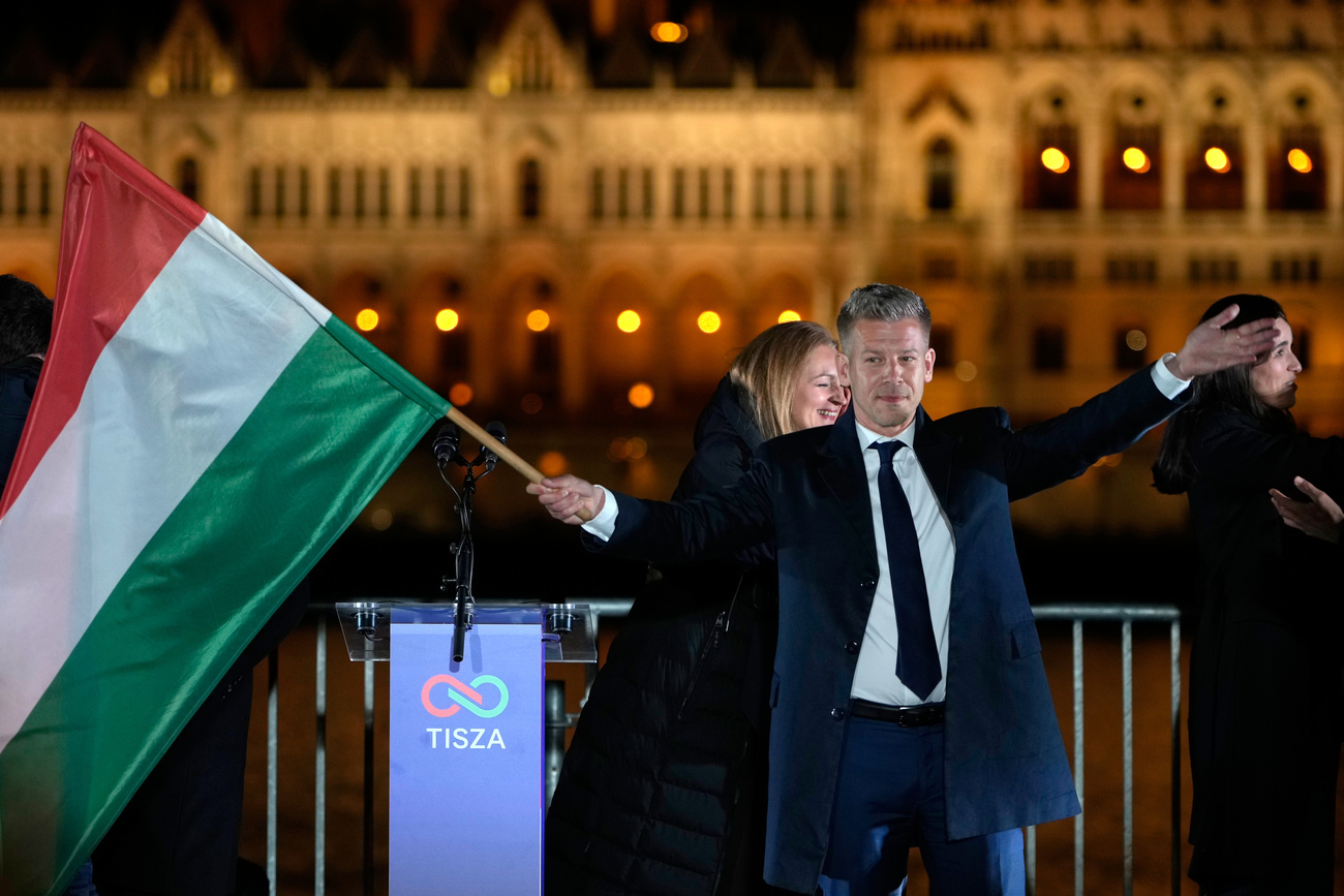 a man holding a Hungarian flag
