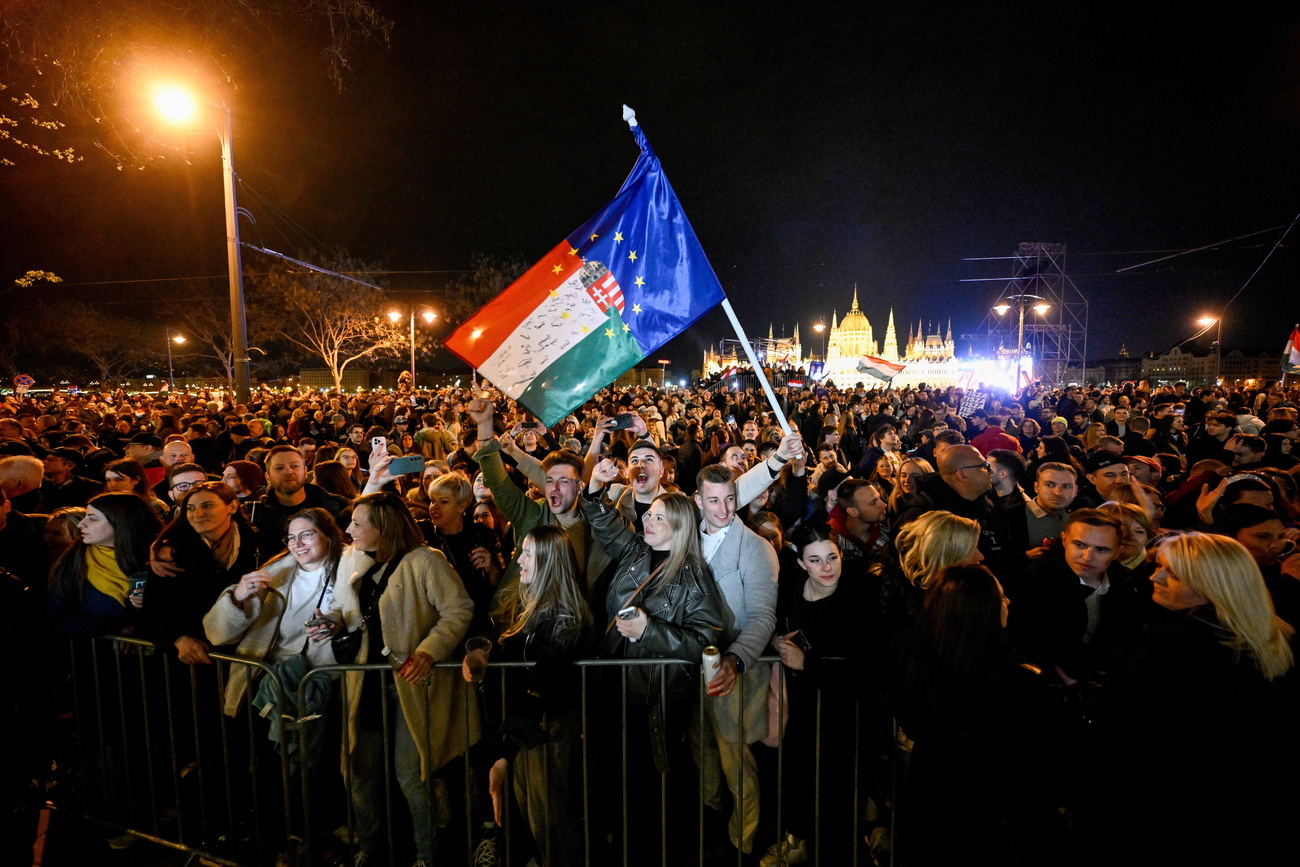 crowd waving a hungarian/EU flag