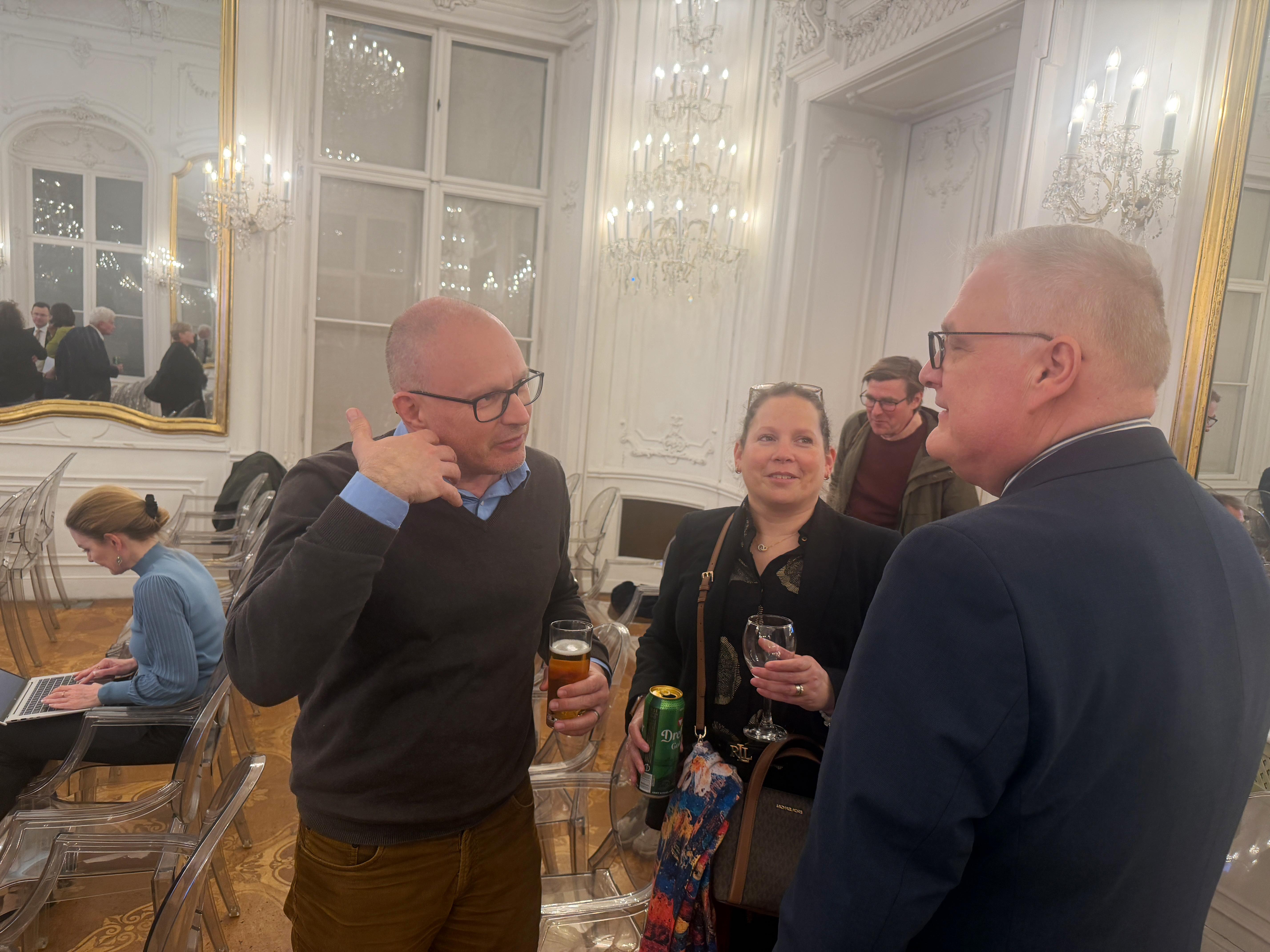 Zoltán Tamassy with his wife Orsolya at the election party, pictured here talking to Zoltán Pállinger, political scientist and Vice-Chancellor of Andrássy University.