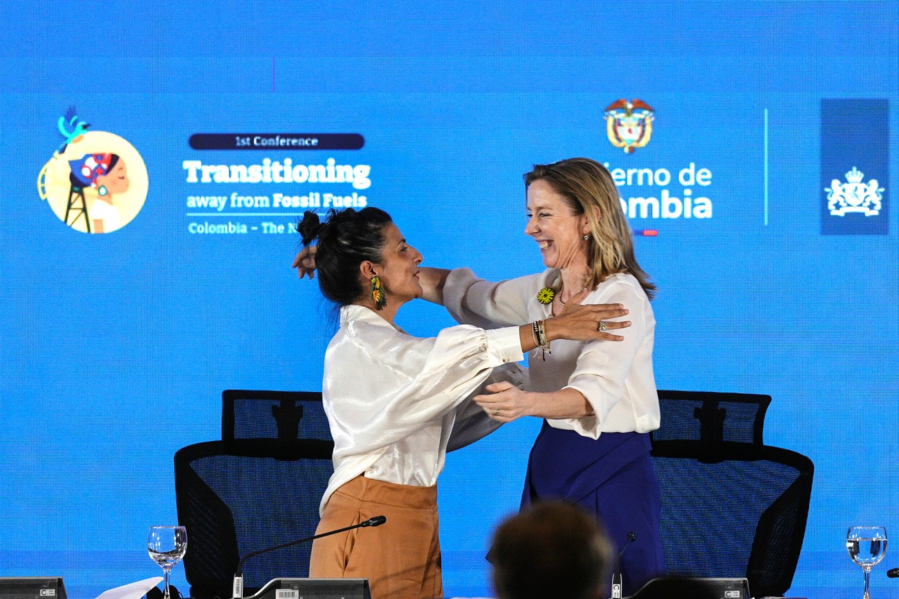 Two women are hugging on stage