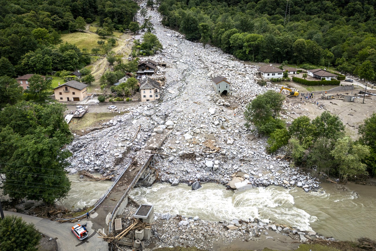 a village half-buried by a landslide of boulders and debris.