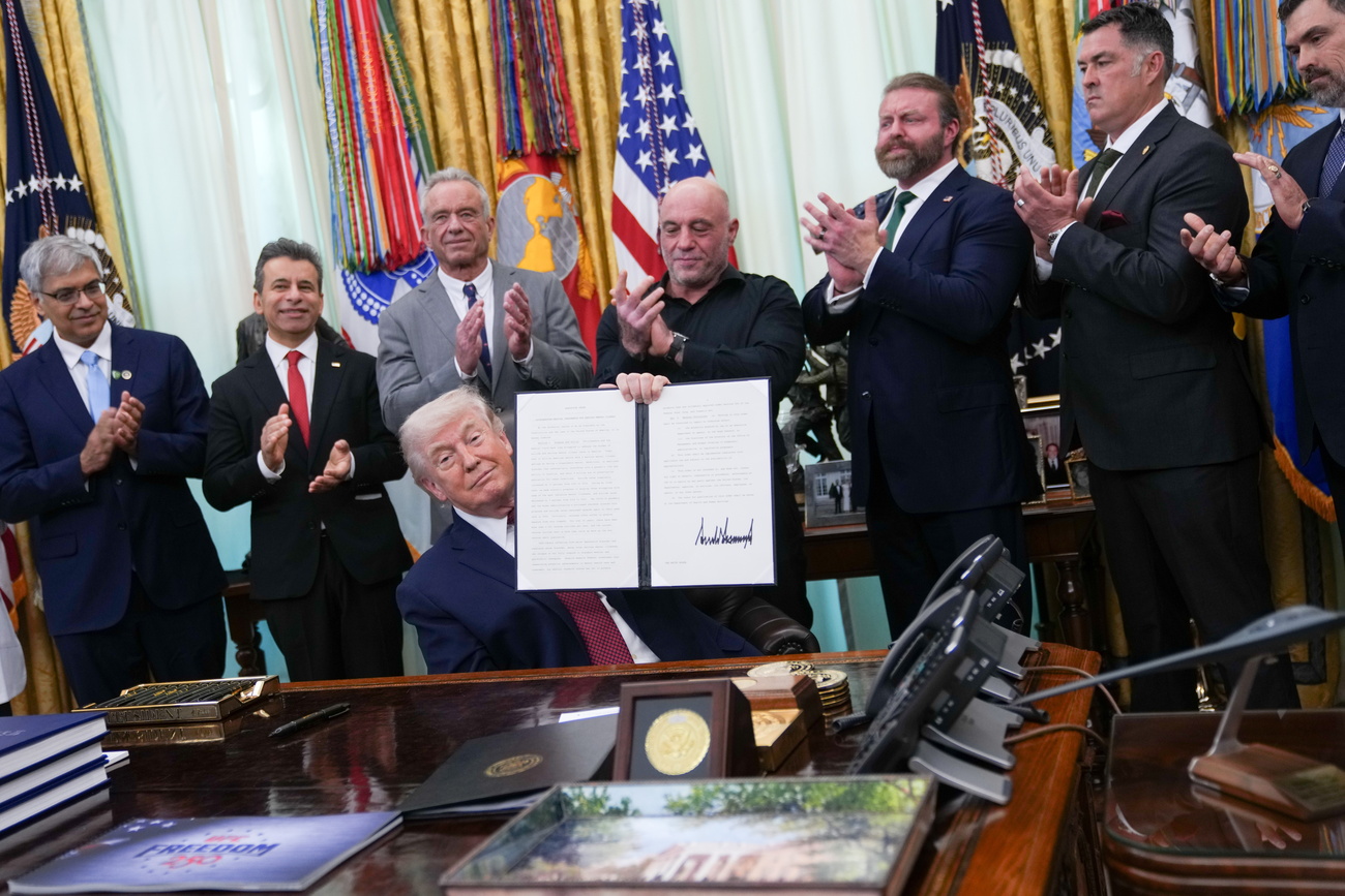 Trump holds up executive order in favour of research and access to psychedelic treatments for mental health in the White House's Oval office.