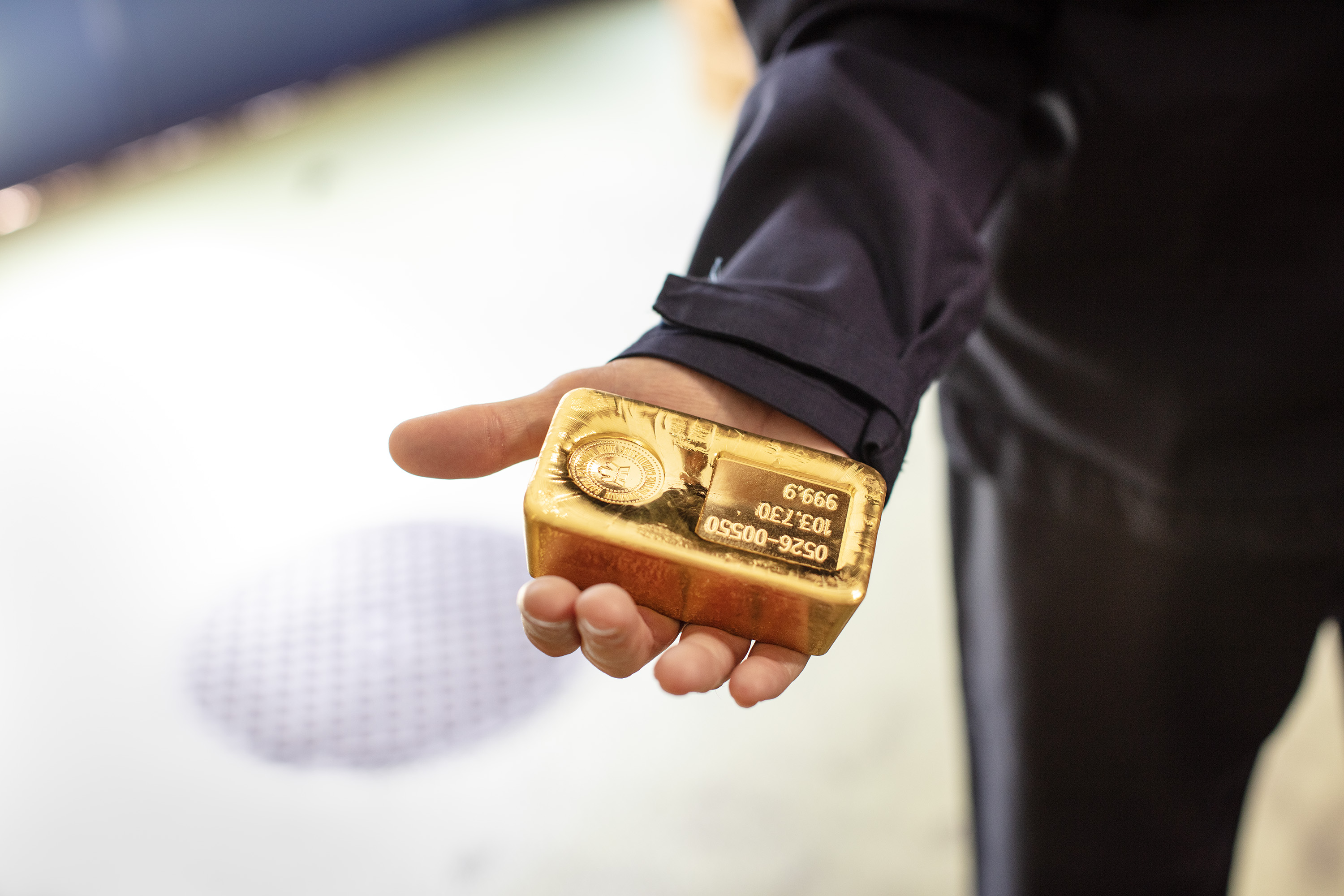 Goldbarren in Hand