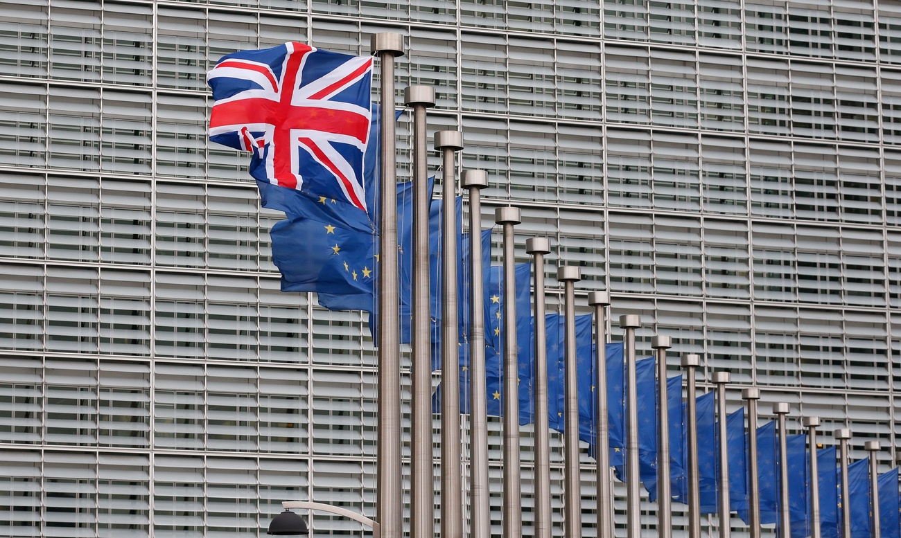 A row of European Union flags with a flag of the United Kingdom in the foreground