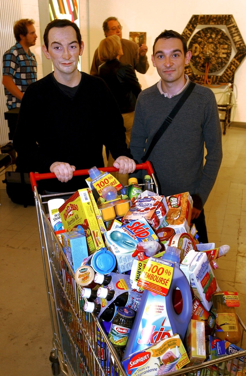 Art fairs are for shopping, right? French artist Matthieu Laurette, on the right, poses next to his artwork "The Treebie King" at LISTE 02, June 2002.