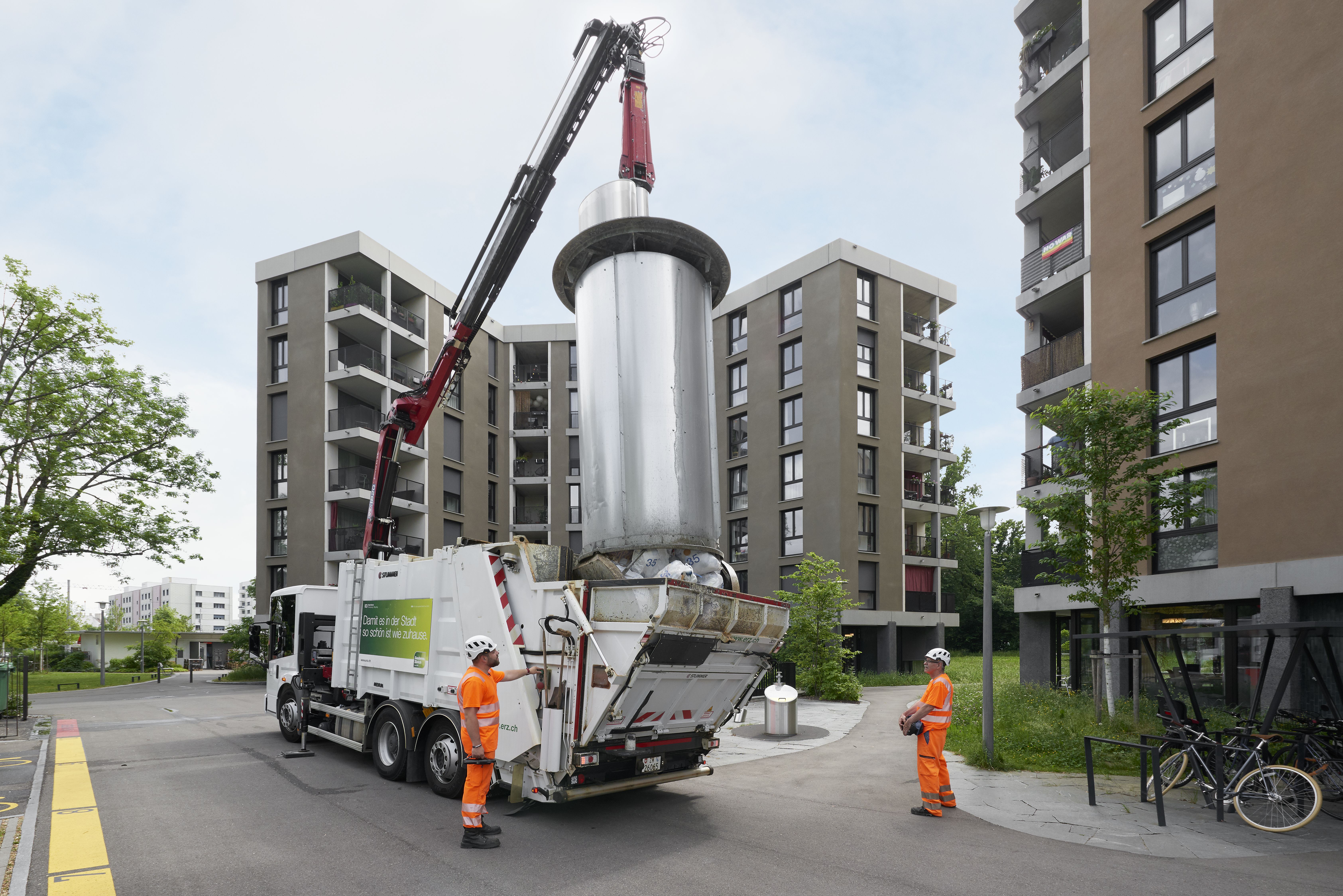 Rubbish collectors in Zurich, Switzerland, removing recyclables from a collection point.