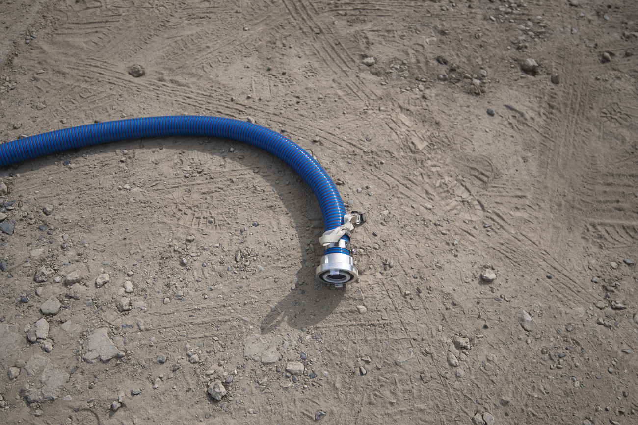 Water hose lying on dry ground.