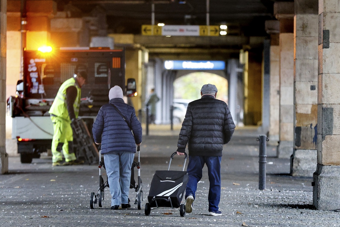 Un couple de personnes âgées sous les arcades d'une ville à l'étranger